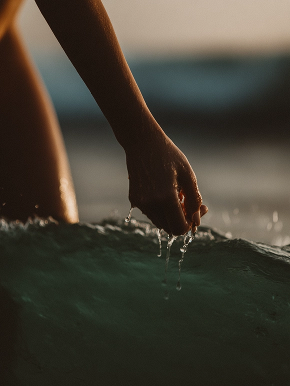 Woman's hand across water